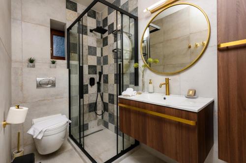a bathroom with a toilet and a sink and a shower at Enavlion Luxury Domes in Panayia