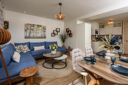 a living room with a blue couch and a table at Enavlion Luxury Domes in Panayia