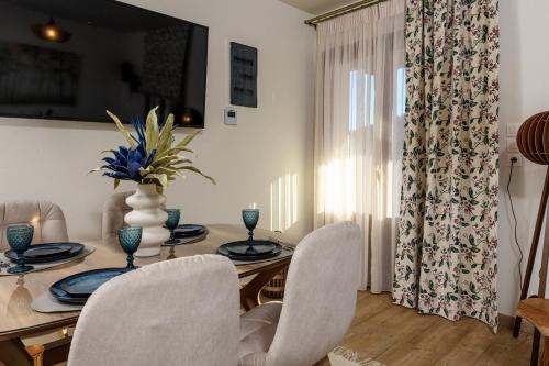 a dining room with a table and chairs and a window at Enavlion Luxury Domes in Panayia