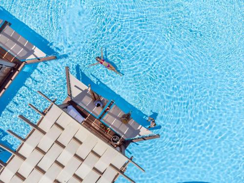 an overhead view of a boat in a swimming pool at Rixos Sharm El Sheikh - Adults Only 18 Plus in Sharm El Sheikh