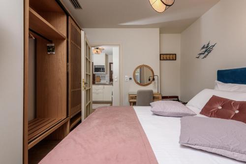 a bedroom with a large bed and a mirror at Enavlion Luxury Domes in Panayia