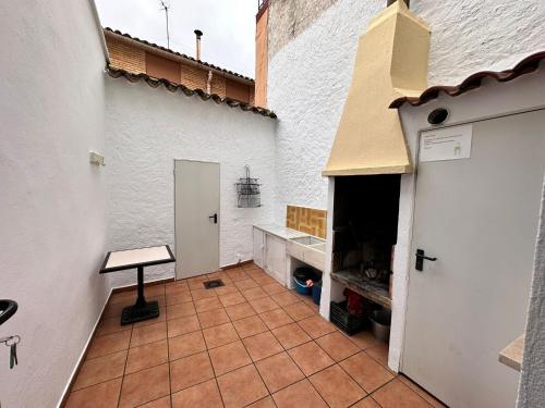 a kitchen with a tile floor and a white wall at Casa Rural Hoces del Cabriel in Villargordo del Cabriel