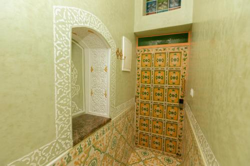 a bathroom with a door with a mirror in it at Colorful traditional Riad w/views of Spain in Tangier