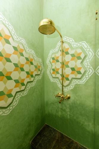 a shower with a lamp in a green bathroom at Colorful traditional Riad w/views of Spain in Tangier