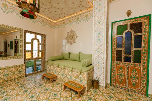 a living room with a couch and a door at Colorful traditional Riad w/views of Spain in Tangier