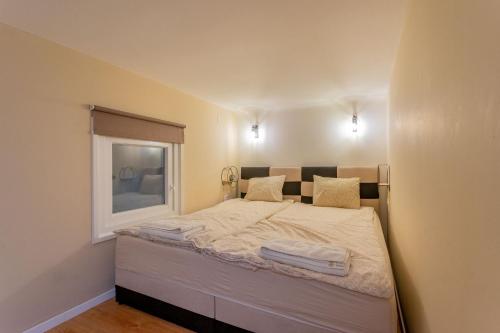 a small bedroom with a bed with a window at Full equipment designed apartment in the heart of Budapest for 4 people in Budapest