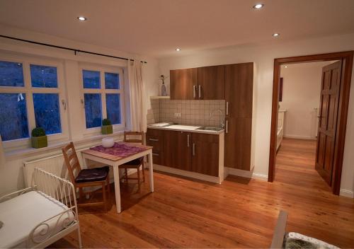 a kitchen with a table and a small table and chairs at Alte Schüre in Elpe