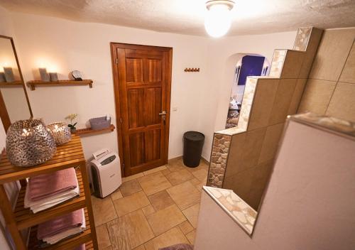 a small kitchen with a refrigerator and a door at Alte Schüre in Elpe