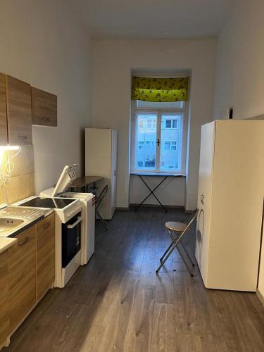 una cucina con elettrodomestici bianchi e una grande finestra di Fantomas*** City Center Apartments No2 3Bedroom + Living room a Szombathely