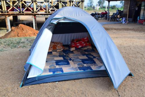a blue tent with a bed in it at Sunny Guest House Hampi in Hampi