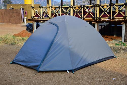 a blue tent sitting on the ground next to a bridge at Sunny Guest House Hampi in Hampi
