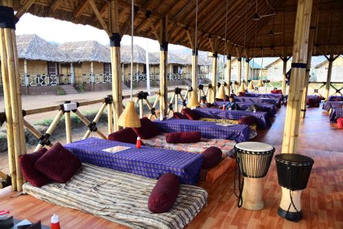 a row of blue couches in a pavilion at Sunny Guest House Hampi in Hampi
