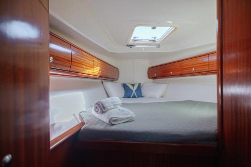 a small bed in the middle of a room at Stay in a Boat - Algarve (Blue Pearl) in Albufeira