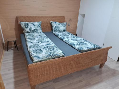 a wicker bed with two pillows on it at Ferienwohnung Anna in Schramberg