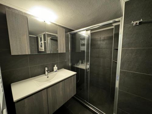 a bathroom with a sink and a shower at Promenade city apartment in Thessaloniki