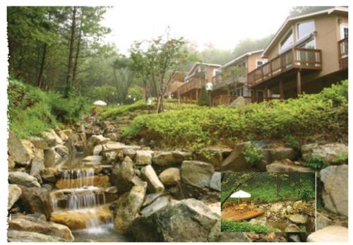 a picture of a creek with rocks and houses at Hue 700 in Pyeongchang 