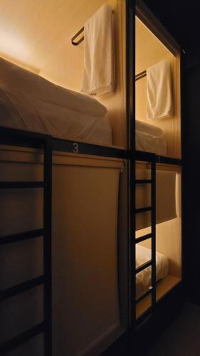 a bunk bed with a mirror in a room at WeStay Budget Hostel in Dubai