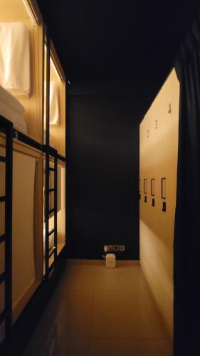 un corridoio vuoto con una stanza buia con finestra di WeStay Budget Hostel a Dubai