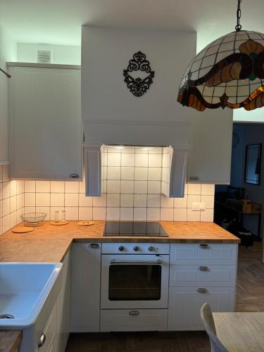a kitchen with white cabinets and a stove top oven at Mazurskie Siedlisko Langen in Mrągowo