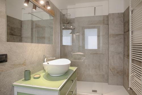 a bathroom with a sink and a mirror at Il posto al sole in Teglio