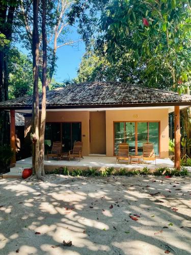 a building with benches in front of it at Sunny Cove Beach Resort Koh Phayam in Ranong