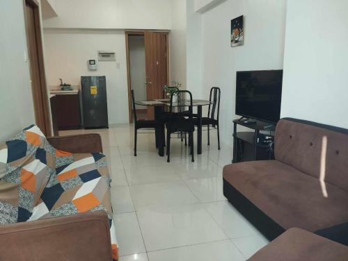 a living room with a couch and a dining room at Roxas Blvd Stunning Studio Condo Near US Embassy in Manila