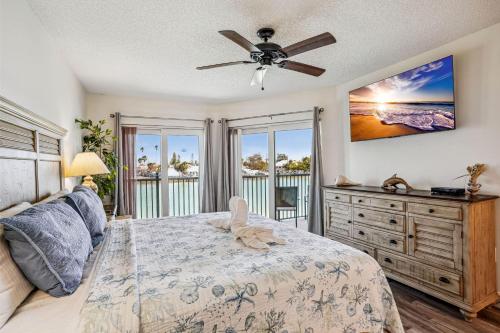 a bedroom with a bed and a ceiling fan at Land's End 3-205 Bay Front - Premier in St. Pete Beach