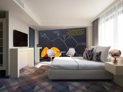 a bedroom with a bed and a chalkboard wall at Science Hotel Prémium in Szeged