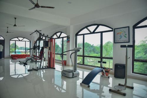 a gym with cardio equipment in a room with windows at International Shri Vidya Peetham (ISVP) in Lucknow