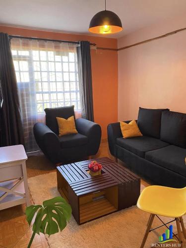 a living room with a couch and a coffee table at Iconic Stays in Eldoret