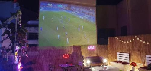 a large projection screen with a baseball game on it at UNITE - Party Building in St Julian's