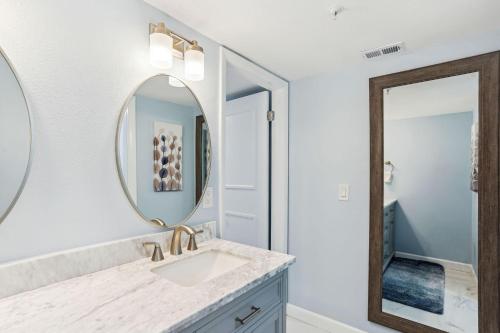 a bathroom with a sink and a mirror at Villa Madeira 408 - Premier in St Pete Beach