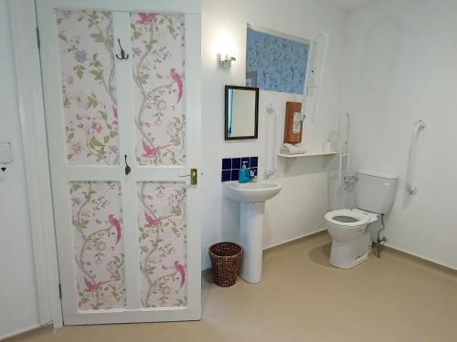 a bathroom with a toilet and a sink at Mapperton Barn House B&B Nr Stourhead & Longleat in Warminster
