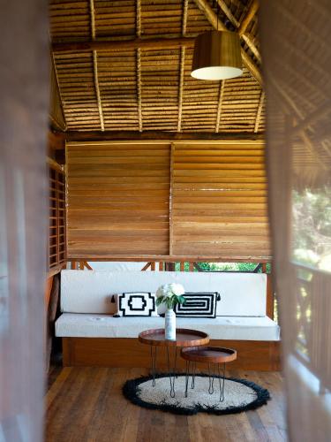 a room with a table and two chairs and a bench at Diana Lodge in Ankify