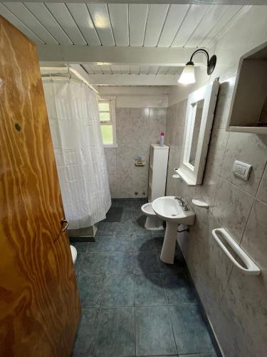 a bathroom with a sink and a toilet at Cabaña La Elisa in Villa La Angostura