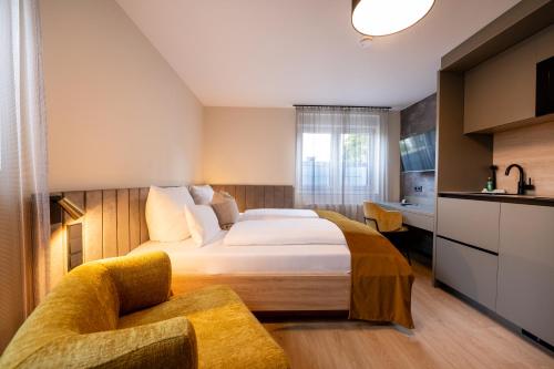 a hotel room with a bed and a chair at V Business Apartments Böblingen in Böblingen