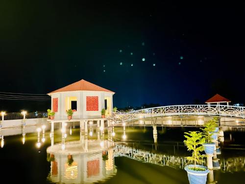 a bridge over a body of water at night at LOTUS in Colonelbāri