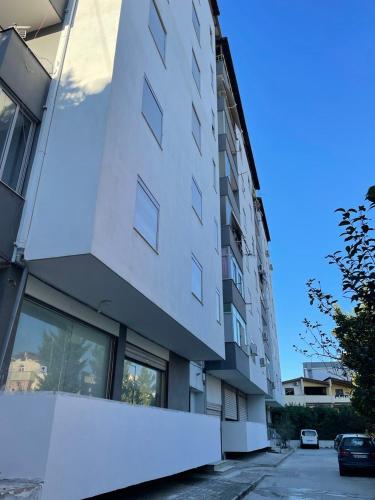 a white building with windows on the side of it at Irene Beach Apartment in Durrës