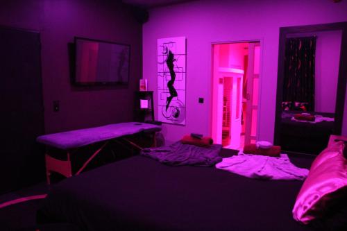 a purple room with two beds in it at SECRET33 in Floirac