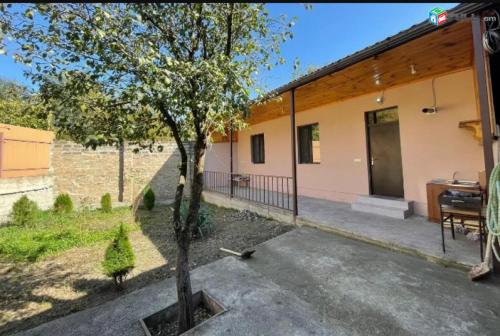 a house with a tree in front of it at Sharambeyan Dilijan Шарамбеян Дилижан ул Шарамбеяна, 34 Շարամբեյան Դիլիջան in Dilijan