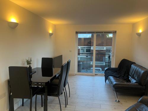 a living room with a table and a couch at Broadway’s Canterbury City Escape in Canterbury