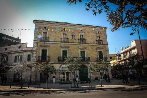 a large brick building with flags on it at B&B Agorà in Bitetto