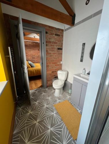 a bathroom with a toilet and a sink at Aplanty House: A Hidden Gem in The Heart of The Fens in Wisbech