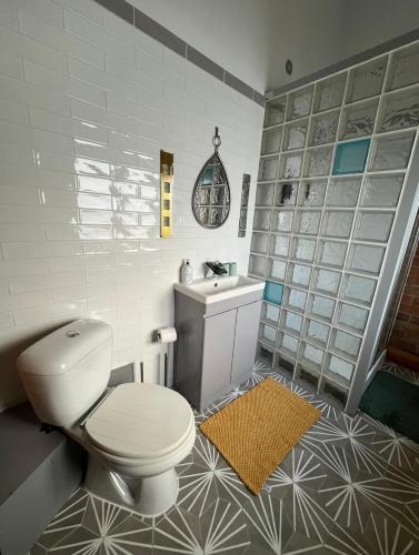 a bathroom with a toilet and a sink at Aplanty House: A Hidden Gem in The Heart of The Fens in Wisbech