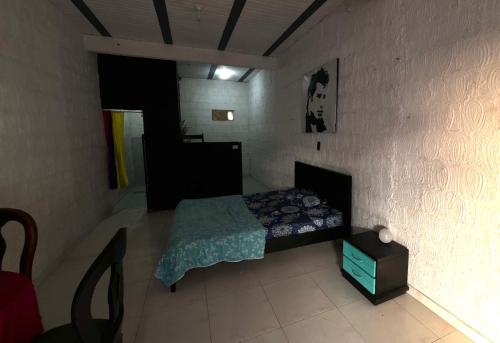 a small bedroom with a bed and a table at Apartaestudio en los llanos in Monterrey