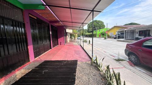 a pink and green building on the side of a street at Apartaestudio en los llanos in Monterrey