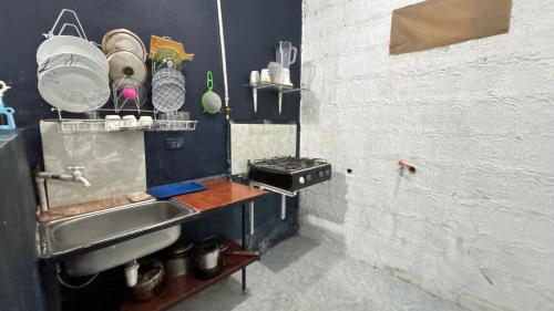 een kleine keuken met een wastafel en een fornuis bij Apartaestudio en los llanos in Monterrey