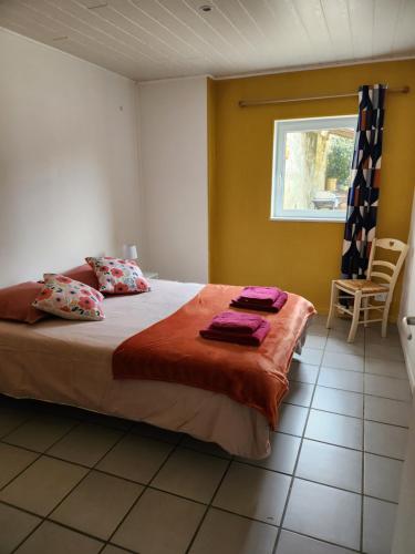 a bedroom with a large bed with a window at Gîte des pins in Saint-Vivien-de-Médoc