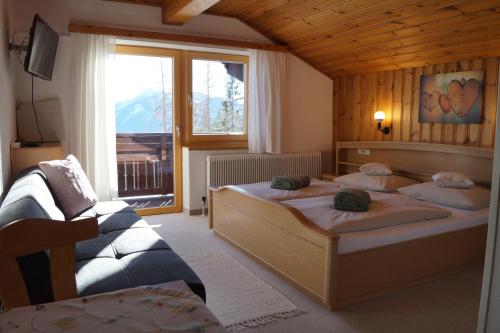 1 dormitorio con 2 camas y ventana en Haus Latschenheim, en Ramsau am Dachstein