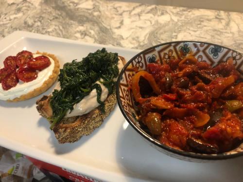 a plate of food with a sandwich and a bowl of food at B&B Convivium in Stazzema